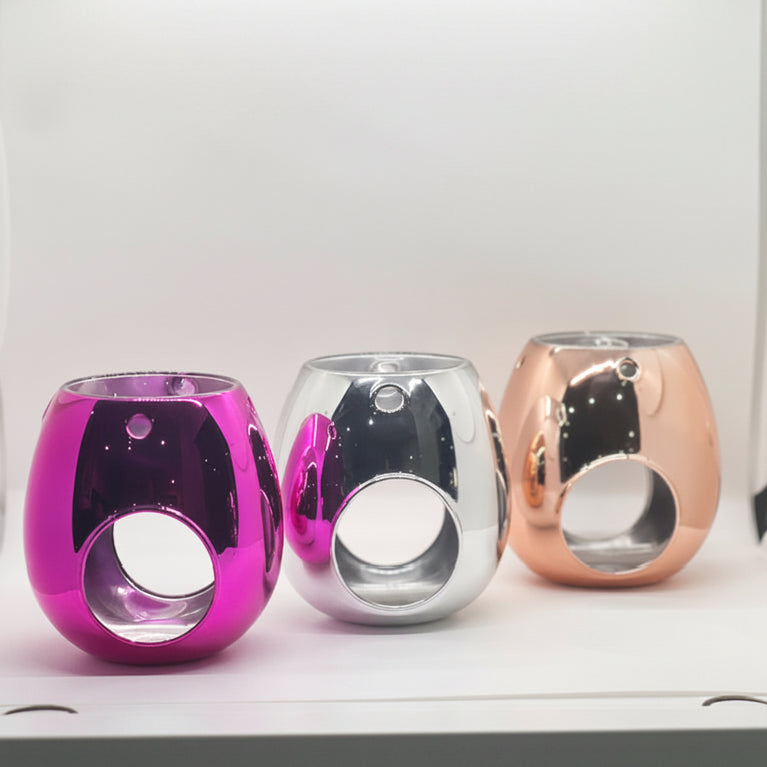Three cylindrical melt burners in pink, silver, and rose gold colors, displayed side by side.